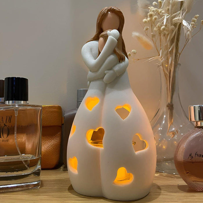 Charmerende mor-datter figur med flimrende lysestage